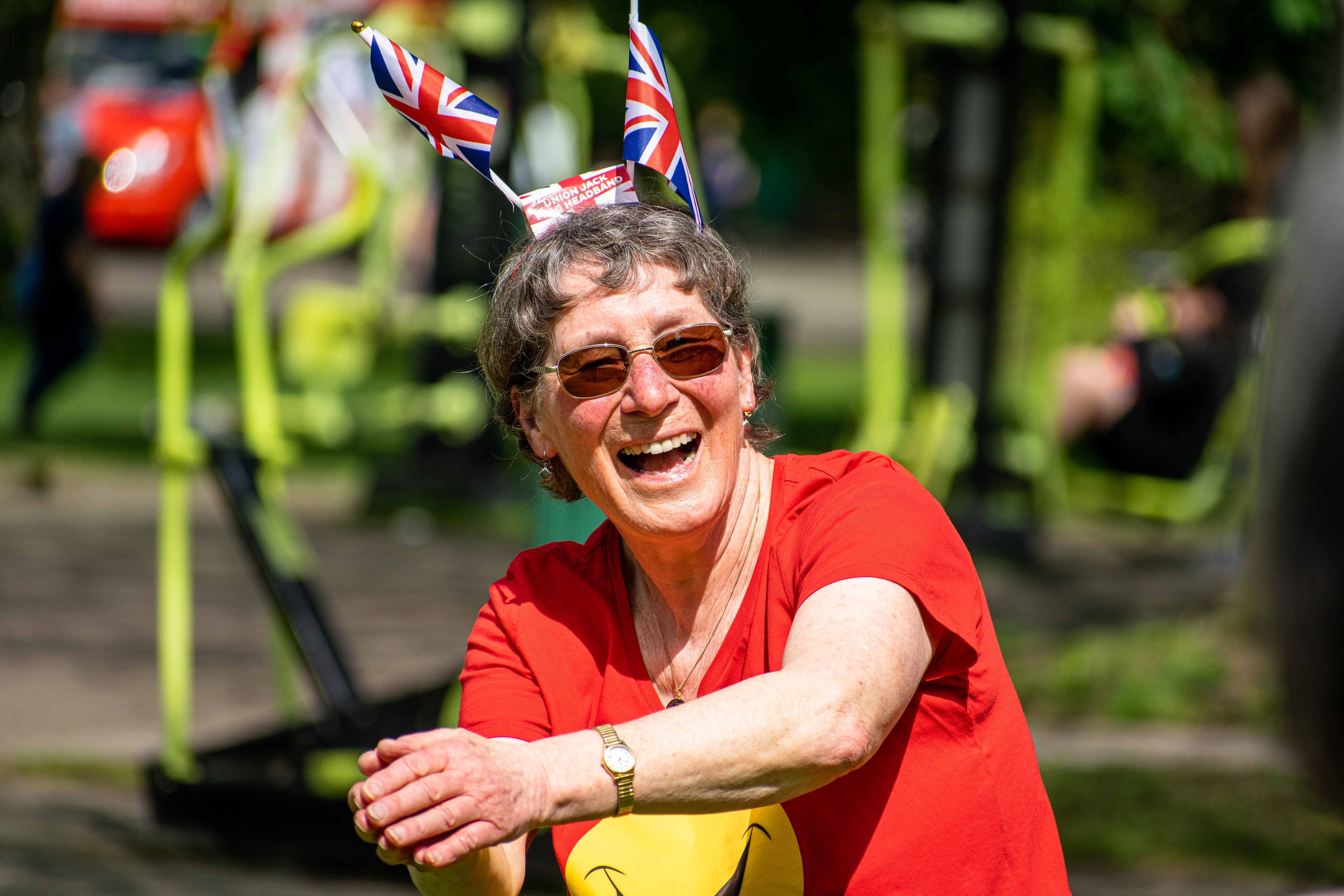 a woman smiling in a red t shirt, clapping 