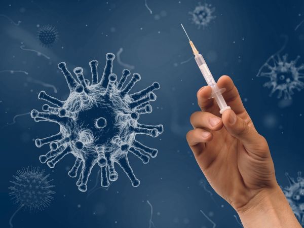 Graphic of a virus and a hand holding a syringe