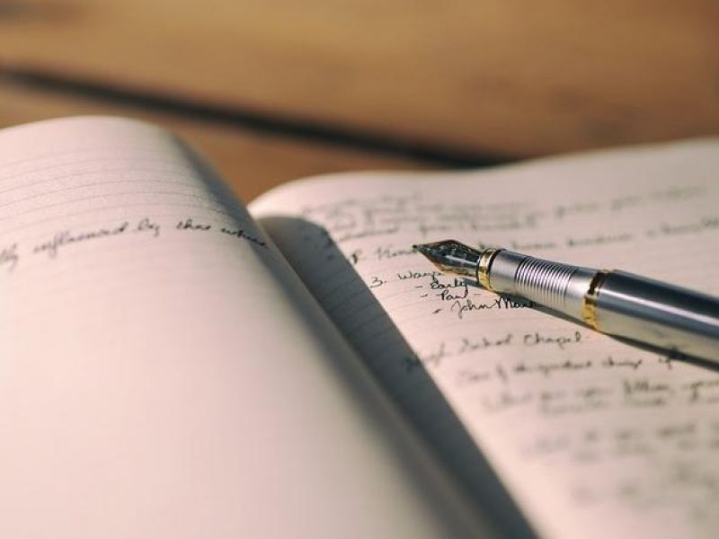 a notebook with fountain pen lying on it