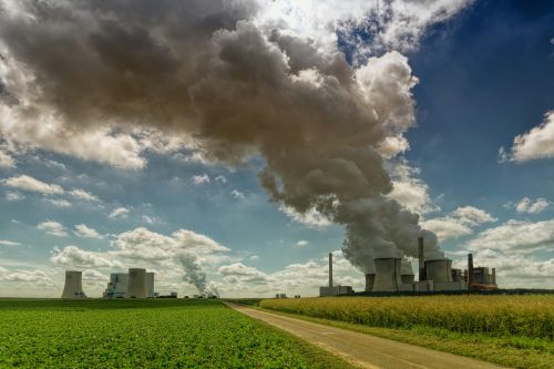 Industrial emissions across a sky and crops