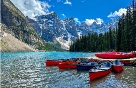 Photo of a lake with canoes