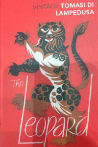 A cover of the Leopard - a red book cover with a drawn image of a leopard. In the top right hand corner, it reads 'Vintage Tomasi Di Lampedusa'