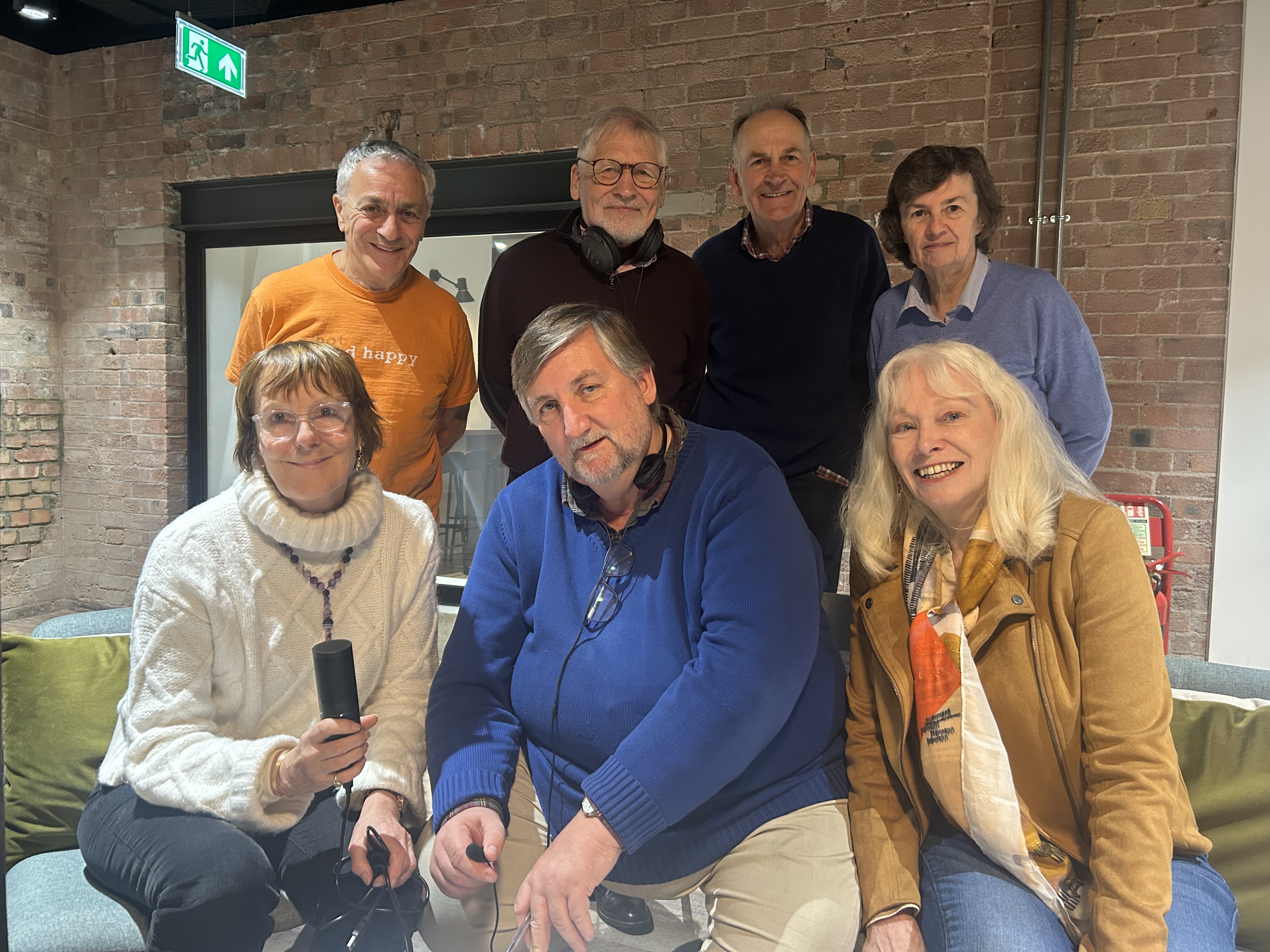 u3a members speaking into a microphone.