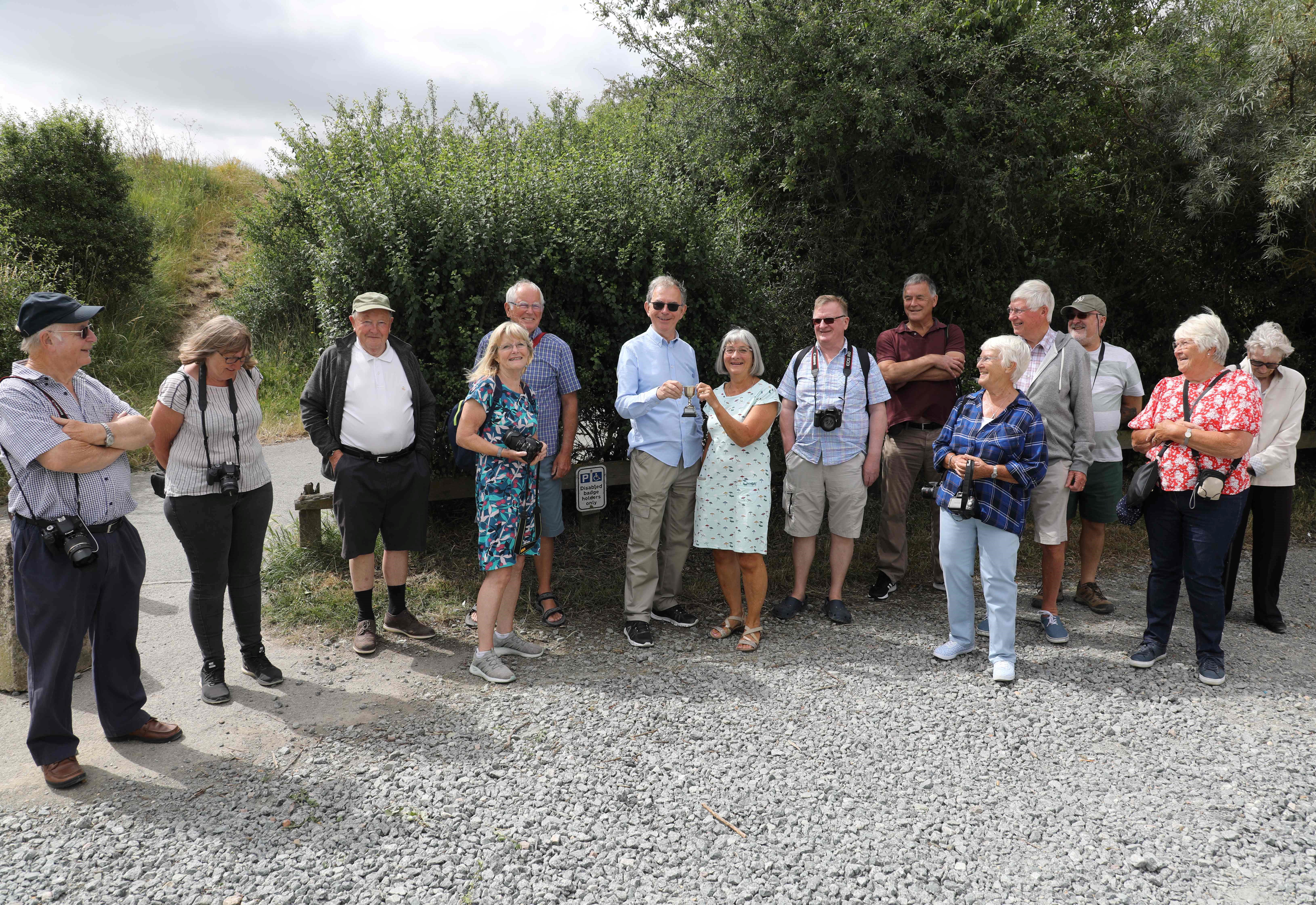 group of people with cameras standing outside