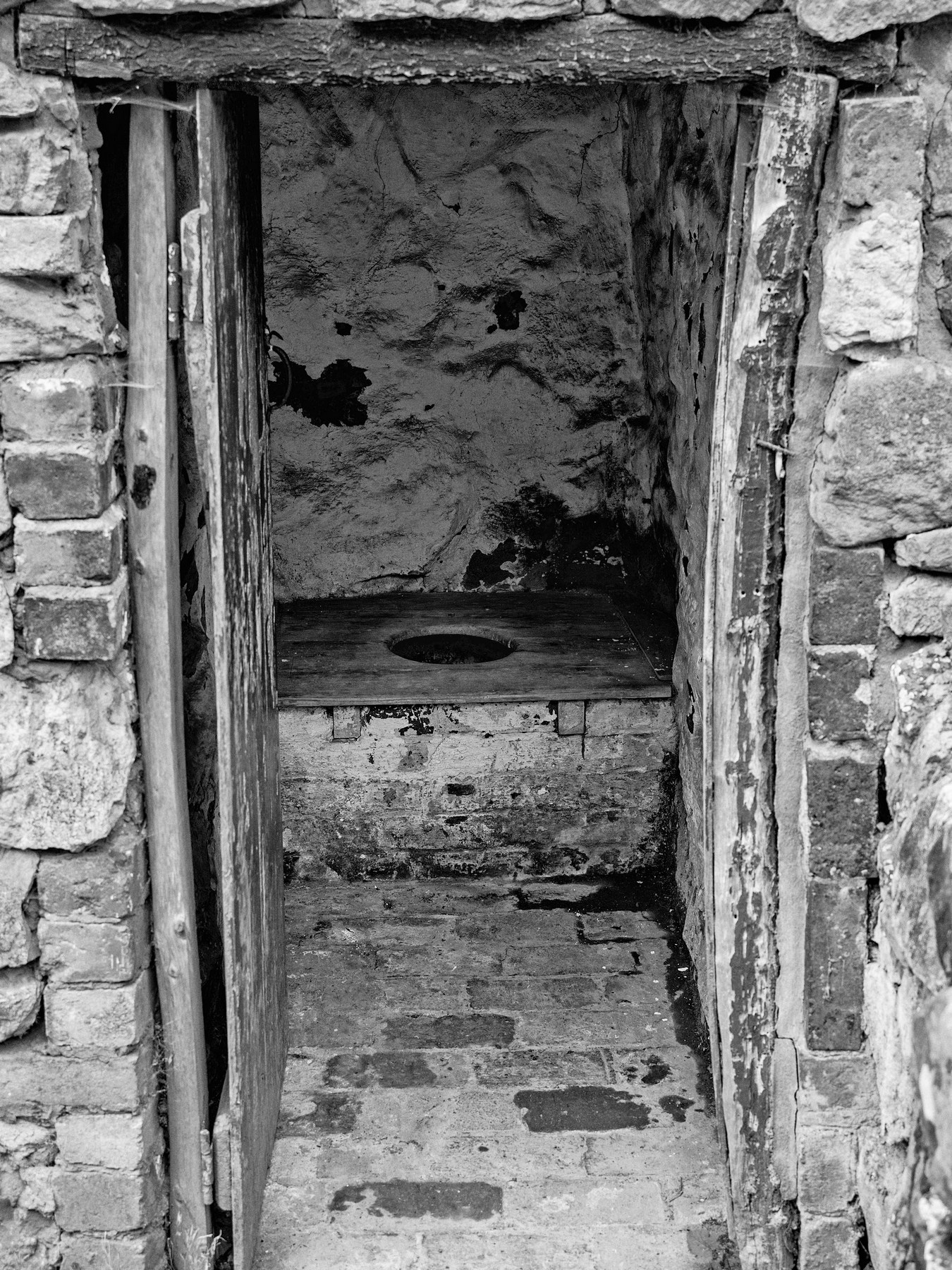 An old lavatory with a wooden seat
