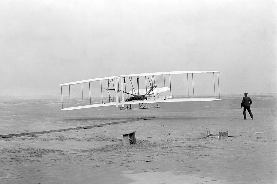 A black and white photo of the wright brothers first flight