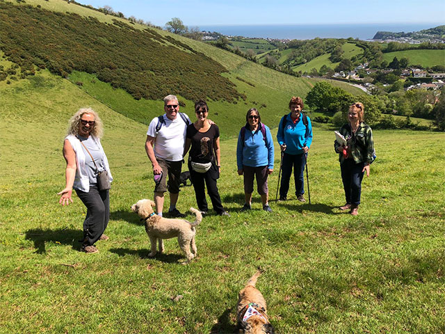 group of people standing on a hill with a dog 