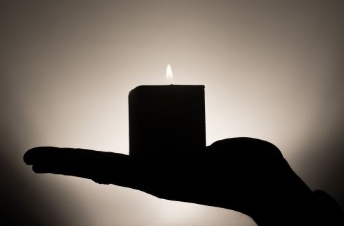 lit candle on a hand