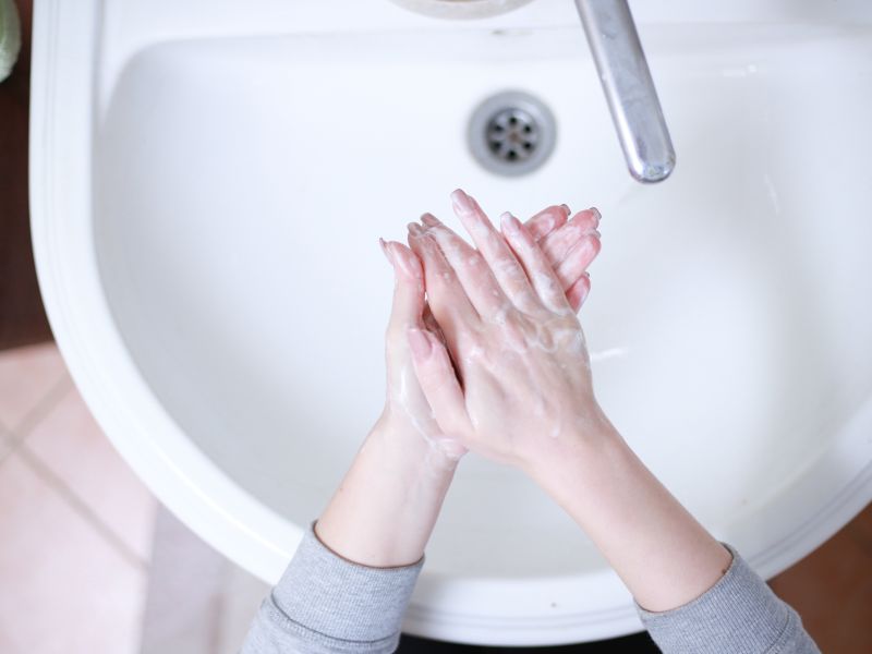 hands washing in a sink