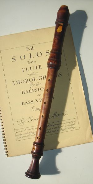 Photo of a wooden recorder with music