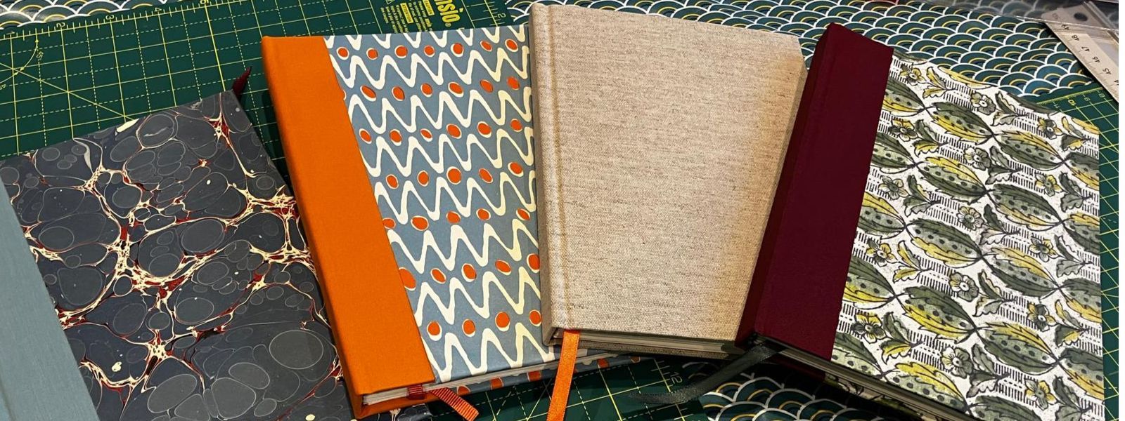 Four home-bound notebooks