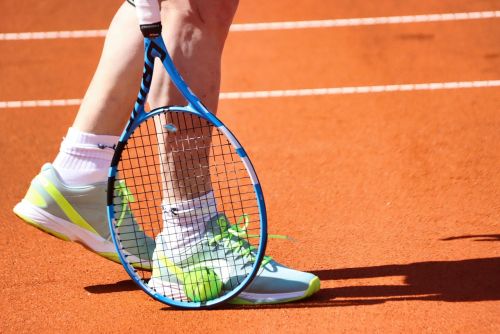 Feet and racket of a tennis player