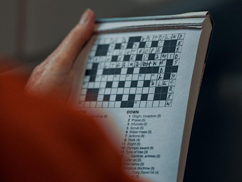 hand holding a paper crossword