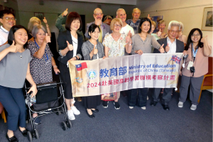 Members of Croydon u3a with delegates from the Taiwan Ministry of Education holding a banner