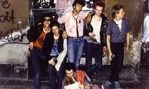 Punk band from the seventies in front of a graffitied wall