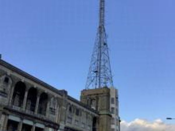 blue sky with the spire of alexandra palace in the foreground