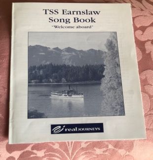 a photo of an old looking booklet entitled 'TSS Earnslaw Song Book, Welcome Aboard'.