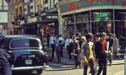Swinging sixties on Carnaby Street People and a car on a street in the sixties