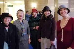 Members of Worthing u3a dressed in period costume and smiling at the camera