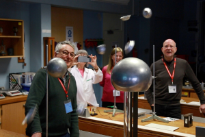 Members watching a static electricity plasma ball result in tinfoil muffin cases flying through the air