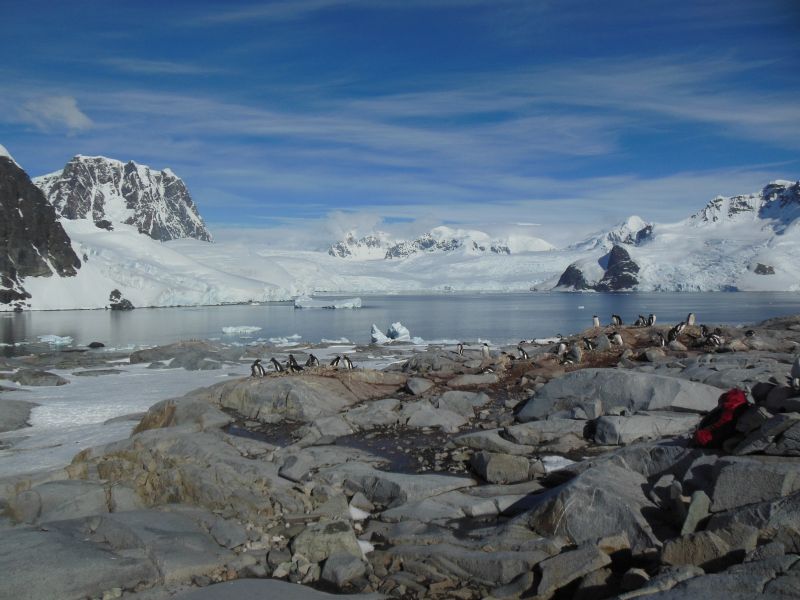 icy landscape with snow in background and blue sky