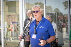 Allan Walmsley, wearing a blue u3a polo shirt, giving a speech at u3a Festival 24