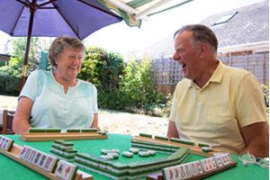 two older adults laughing together