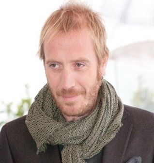 man with blonde ish hair, scarf and facial hair