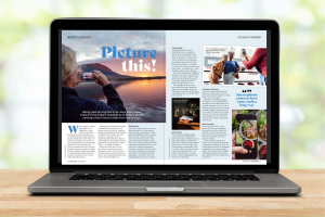 a laptop has a double page spread of a magazine open on the screen