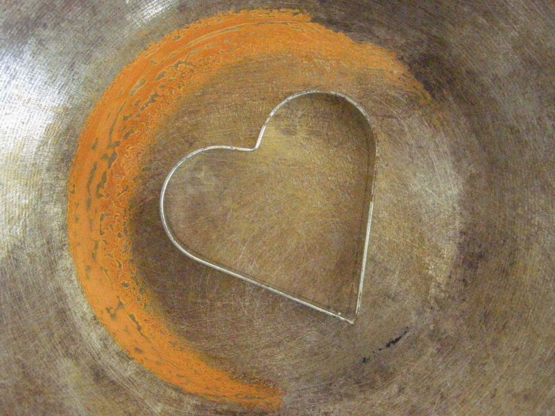 A heart cookie cutter on a textured surface