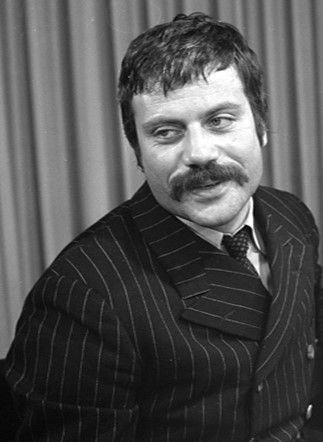 a black and white photo of a man in a pin stripe suit with a moustache