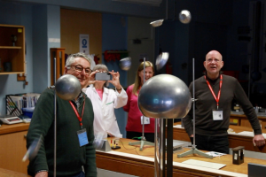 people in a science lab watch science experiments