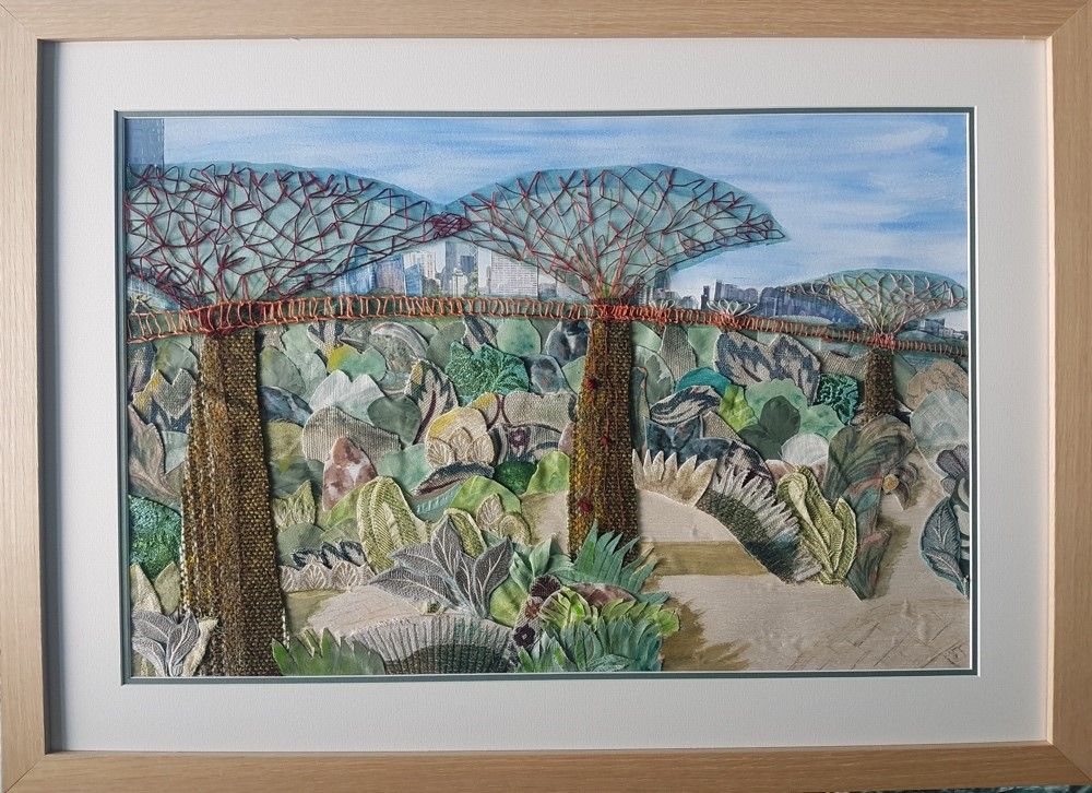 collage of trees and a bridge, stitched on paper
