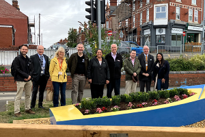 Wyre Forest u3a member Sue with representatives from Network Rail, West Midlands Trains and Worcestershire Community Rail Partnership and Community Rail Network. They are standing behind a boat that has been refurbished by u3a volunteers into a planter.
