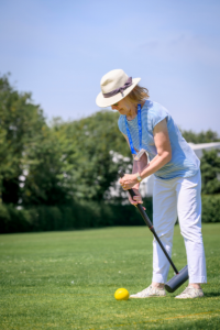 A woman playing croquet, at Festival 24