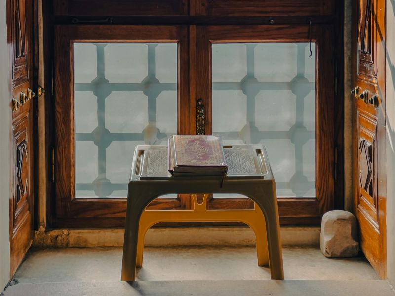 Photo of a religious text on a stand on a window ledge