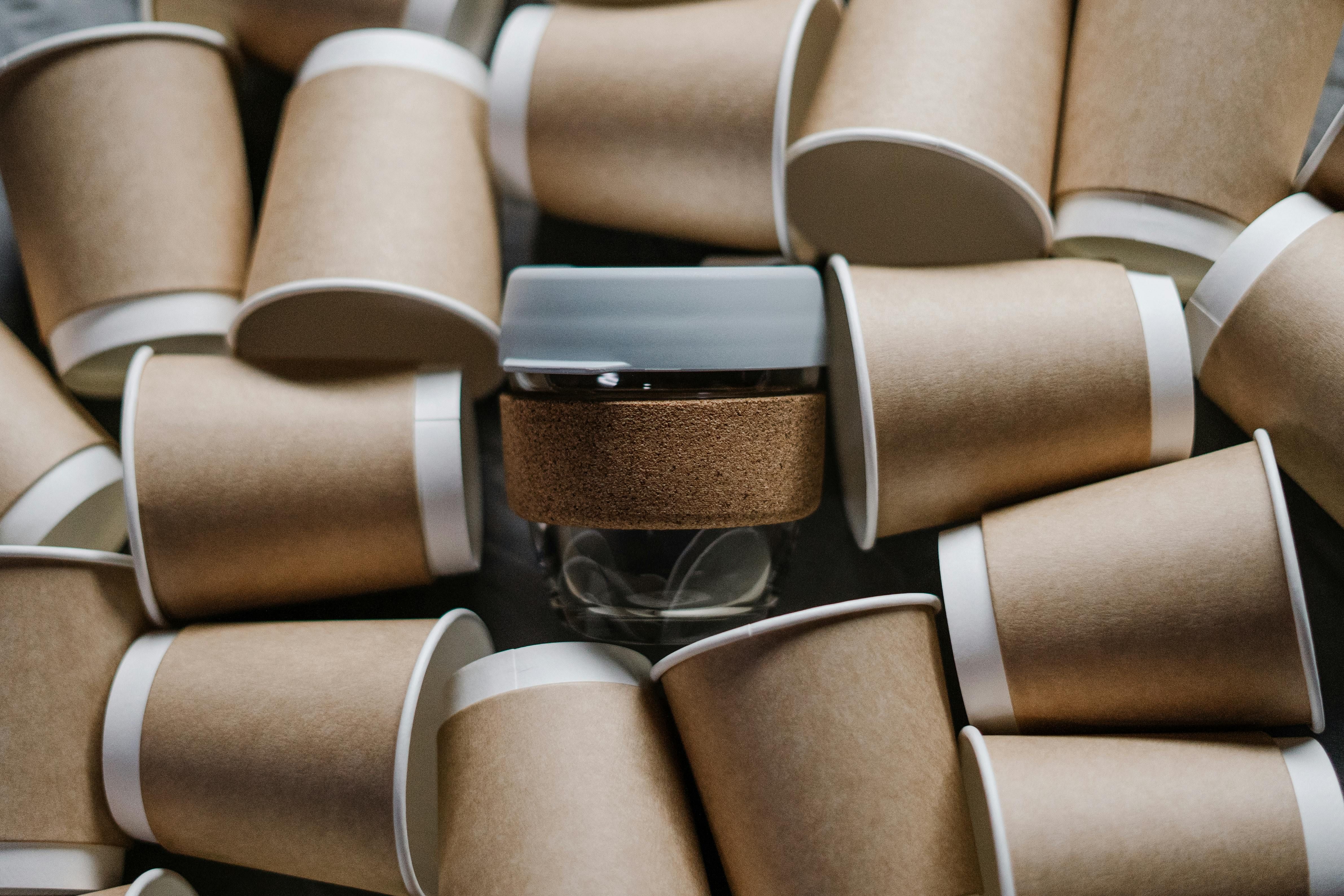 Photo of a reusable cup among disposable cups